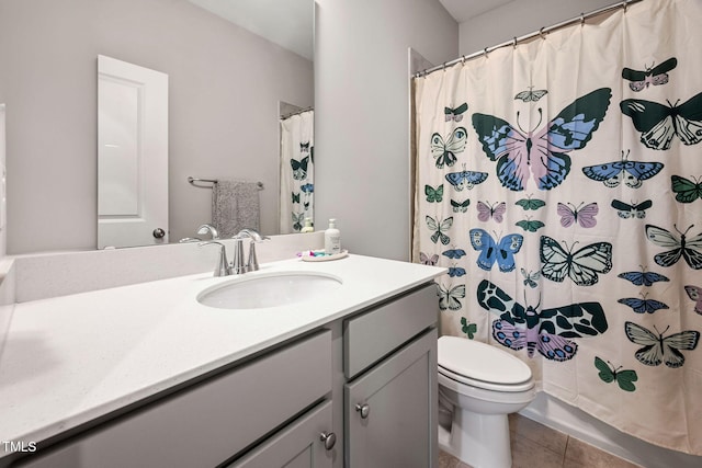 bathroom featuring walk in shower, toilet, tile patterned floors, and vanity