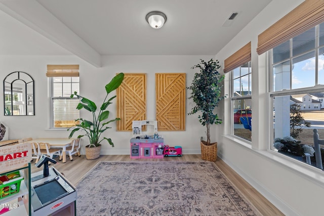 playroom with hardwood / wood-style floors and beam ceiling