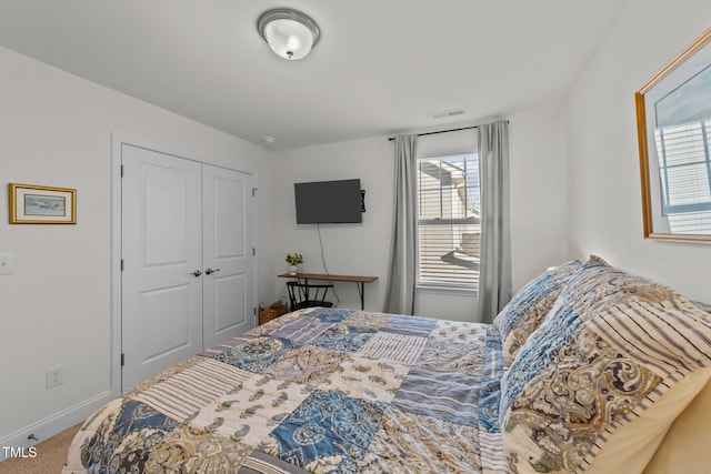 bedroom with carpet flooring and a closet