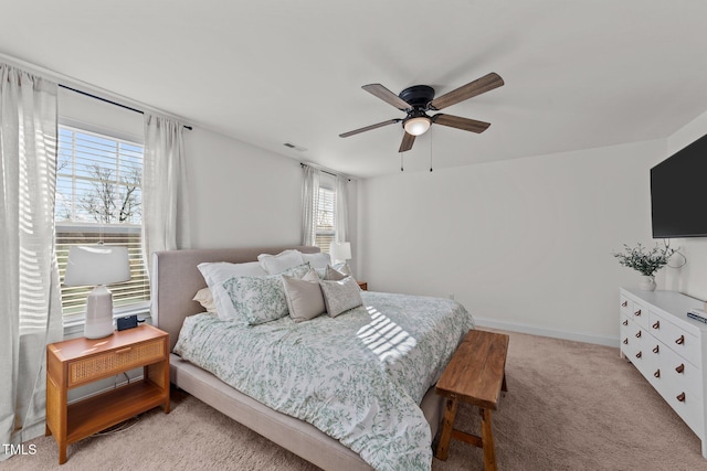 bedroom with light colored carpet and ceiling fan