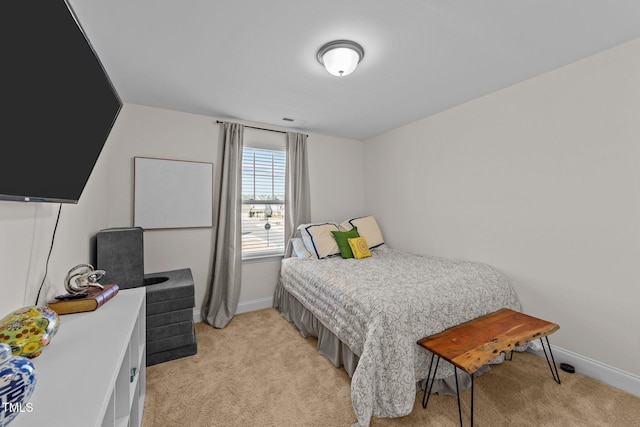 bedroom featuring light carpet