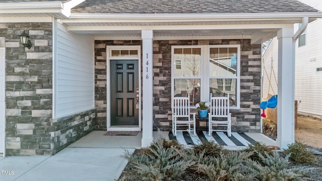 entrance to property featuring covered porch