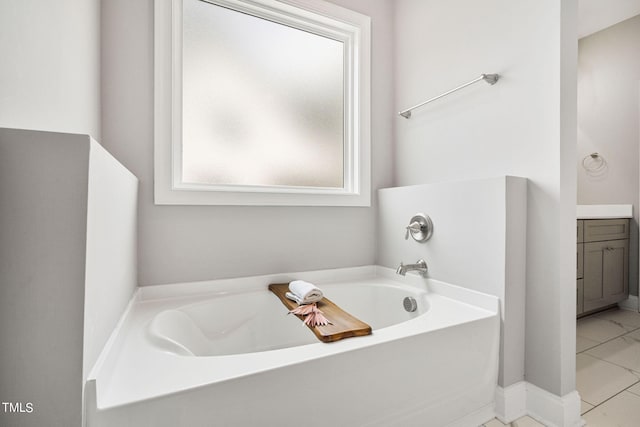 bathroom featuring a bath, tile patterned flooring, and vanity