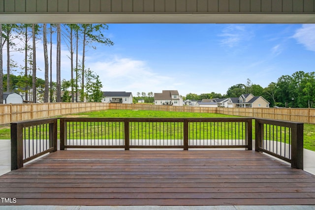 wooden terrace featuring a lawn