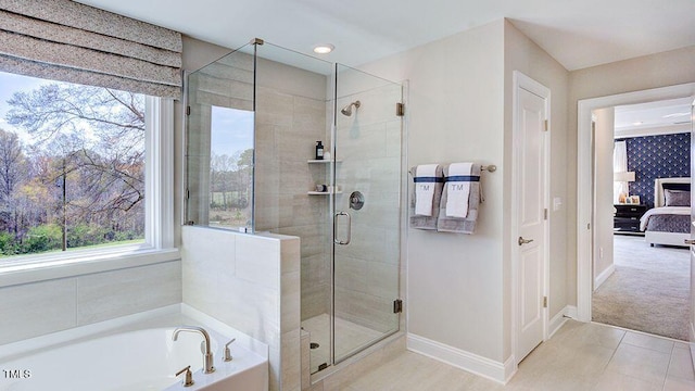 bathroom with shower with separate bathtub