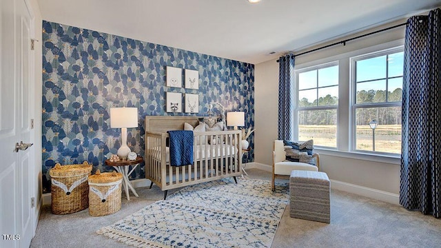 bedroom with carpet and a crib