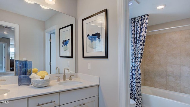 bathroom featuring shower / tub combo and vanity