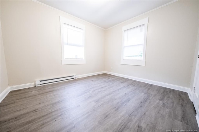 unfurnished room with a baseboard heating unit, dark hardwood / wood-style floors, and crown molding