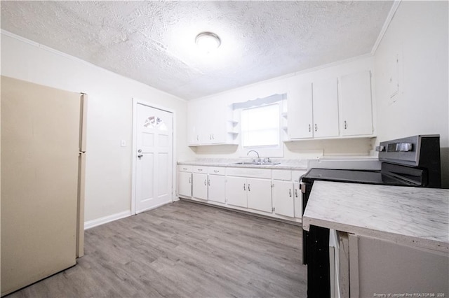 kitchen with sink, white cabinetry, a textured ceiling, and white fridge