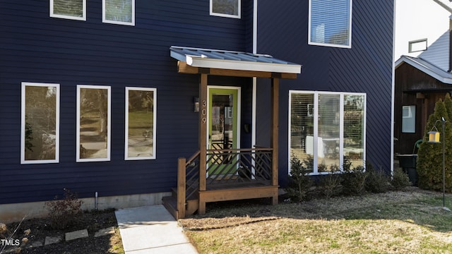 view of exterior entry featuring metal roof and a standing seam roof