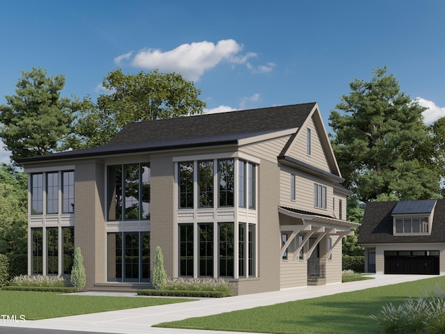 rear view of house featuring a yard and a garage