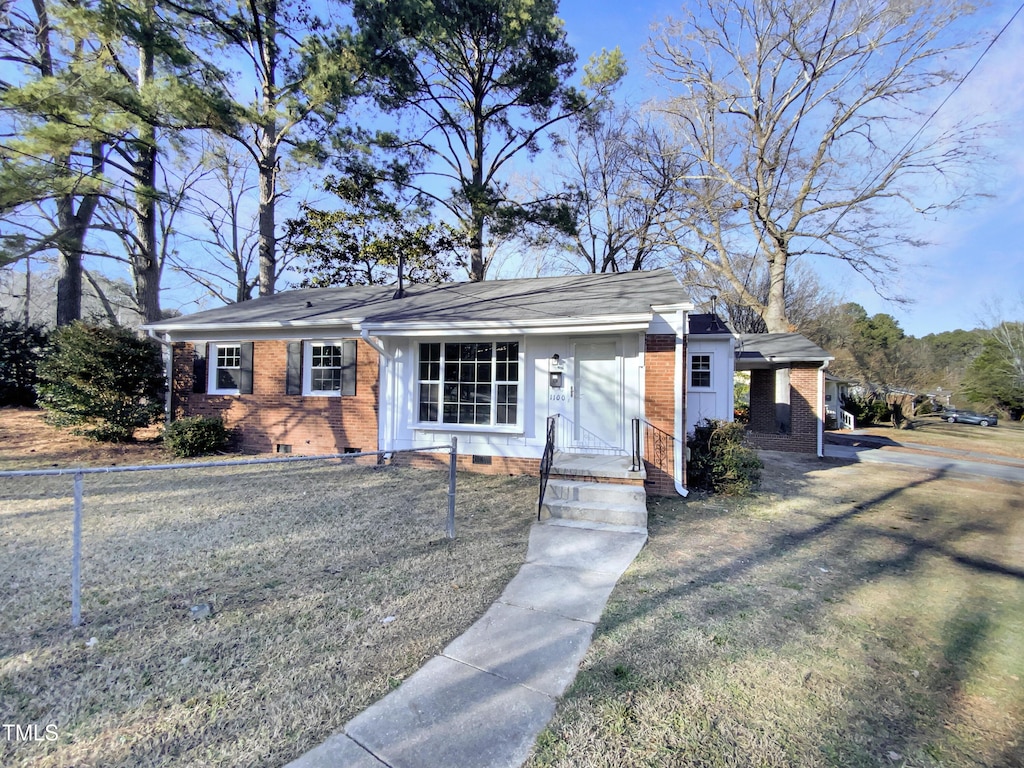 ranch-style home with a front yard