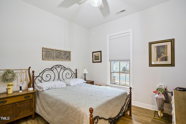 bedroom with ceiling fan and wood-type flooring