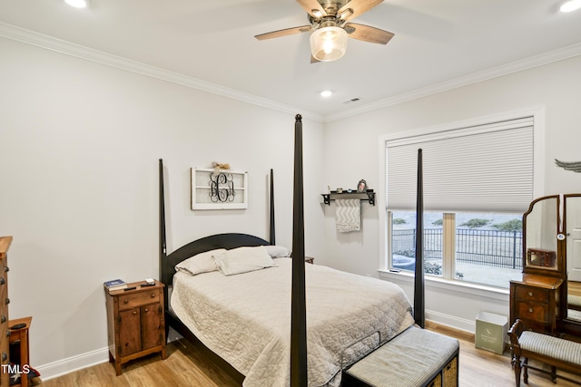 bedroom featuring ceiling fan, light hardwood / wood-style flooring, and crown molding