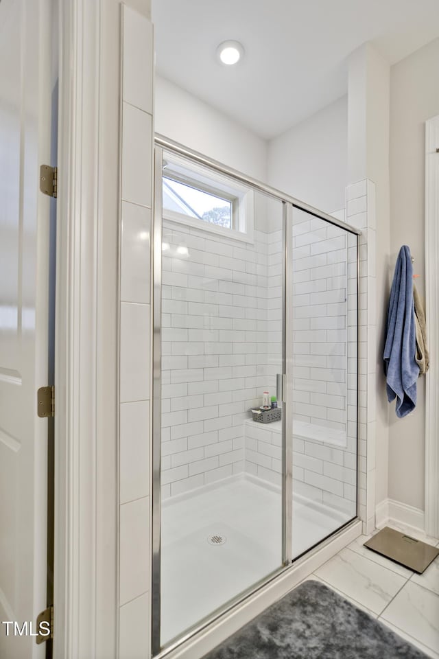 bathroom with a shower with door