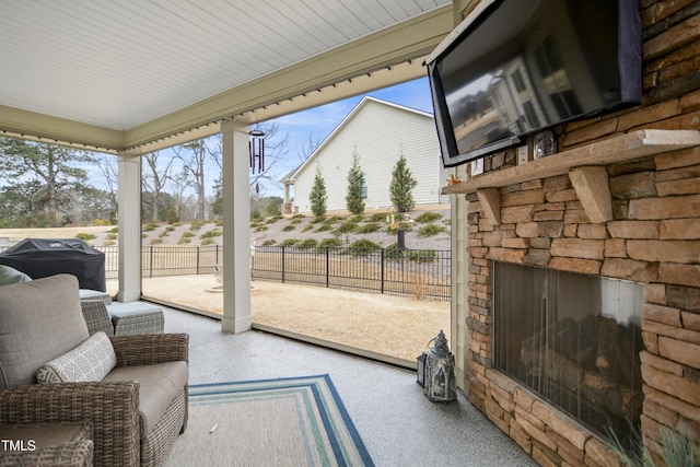 sunroom / solarium with an outdoor stone fireplace