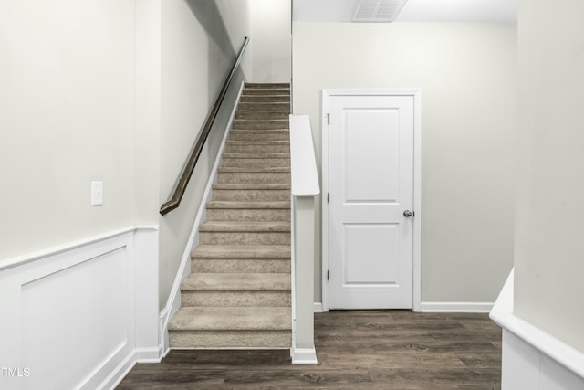 stairs featuring hardwood / wood-style flooring