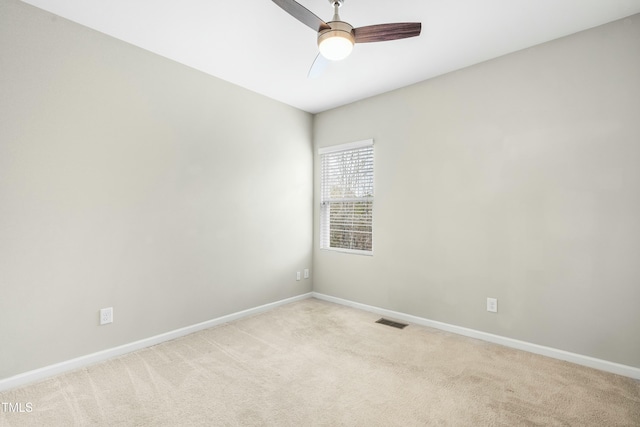 carpeted empty room featuring ceiling fan