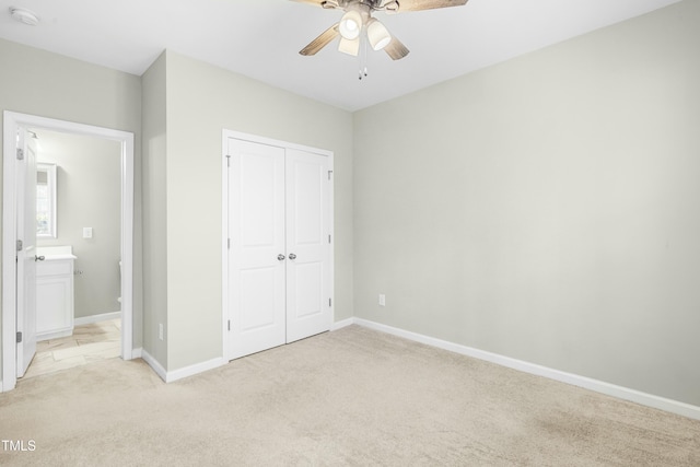 unfurnished bedroom featuring light colored carpet, ceiling fan, and a closet