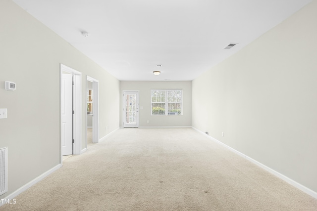 empty room featuring light carpet