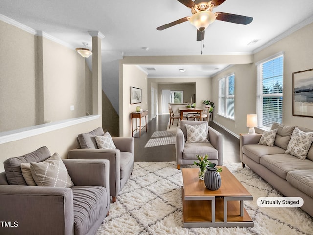 living room featuring light hardwood / wood-style floors, ceiling fan, and ornamental molding