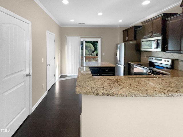 kitchen featuring crown molding, dark hardwood / wood-style flooring, light stone countertops, decorative backsplash, and stainless steel appliances