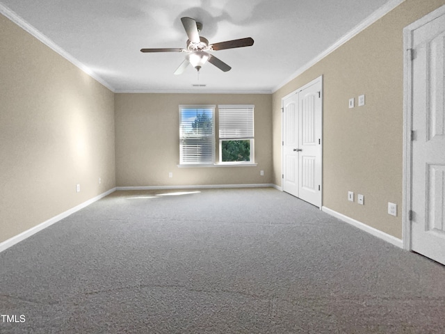 carpeted empty room featuring ceiling fan and ornamental molding