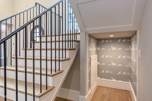 staircase with hardwood / wood-style floors