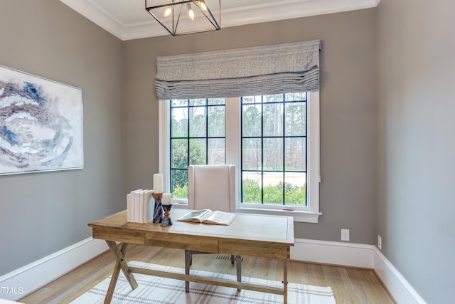 office area featuring ornamental molding, an inviting chandelier, and light hardwood / wood-style flooring