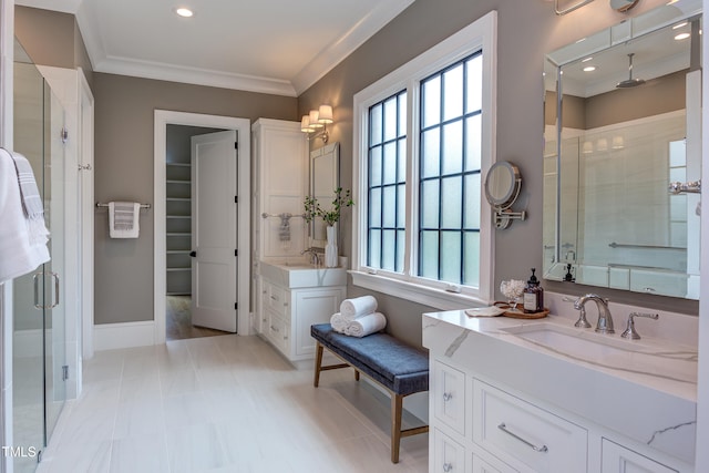 bathroom featuring ornamental molding, vanity, and walk in shower