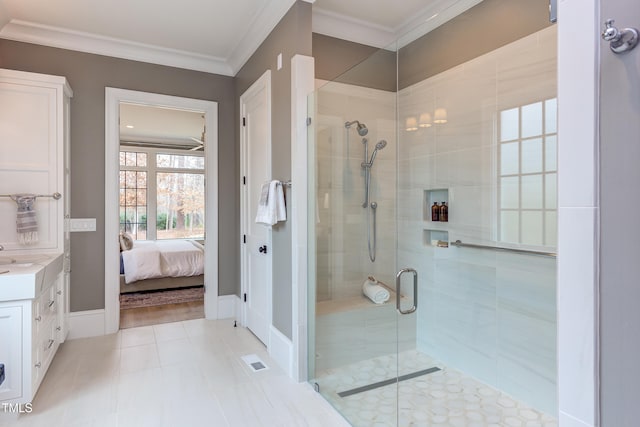 bathroom featuring tile patterned flooring, crown molding, vanity, and walk in shower