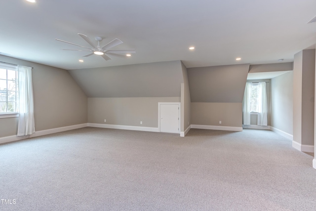 bonus room with light carpet, vaulted ceiling, and ceiling fan