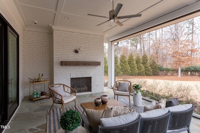 view of patio with an outdoor living space with a fireplace and ceiling fan