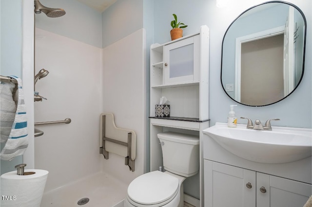 bathroom featuring walk in shower, vanity, and toilet