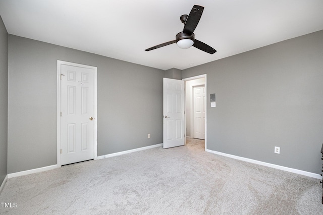 unfurnished bedroom featuring ceiling fan and light colored carpet