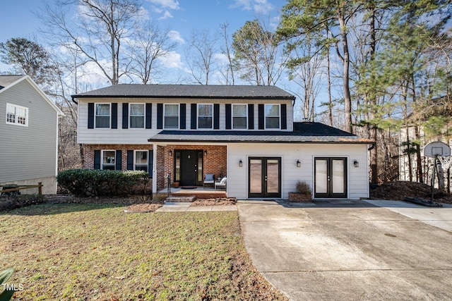 view of front of property with a front lawn and french doors