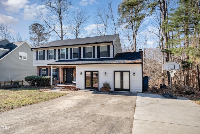 view of front of house with a front lawn and french doors