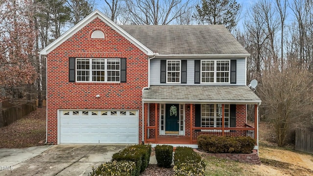 view of property with a porch and a garage