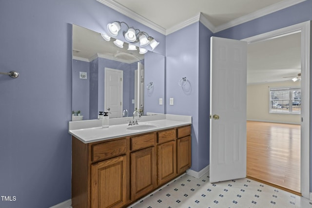 bathroom with ornamental molding, vanity, and ceiling fan