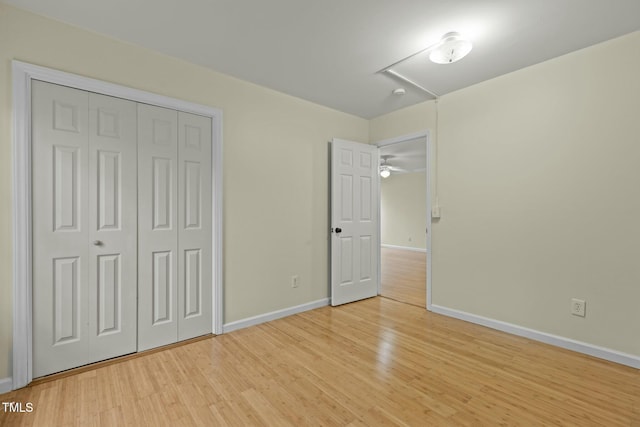 unfurnished bedroom featuring light wood-type flooring and a closet