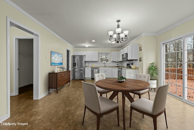 dining area featuring crown molding, sink, and an inviting chandelier