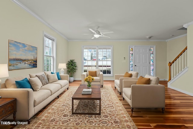 living room featuring hardwood / wood-style flooring, crown molding, and ceiling fan