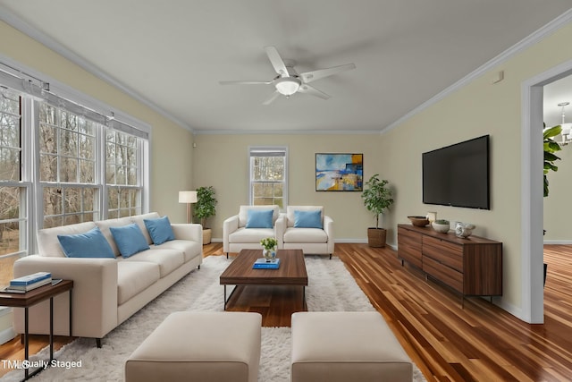 living room featuring crown molding, hardwood / wood-style flooring, and ceiling fan