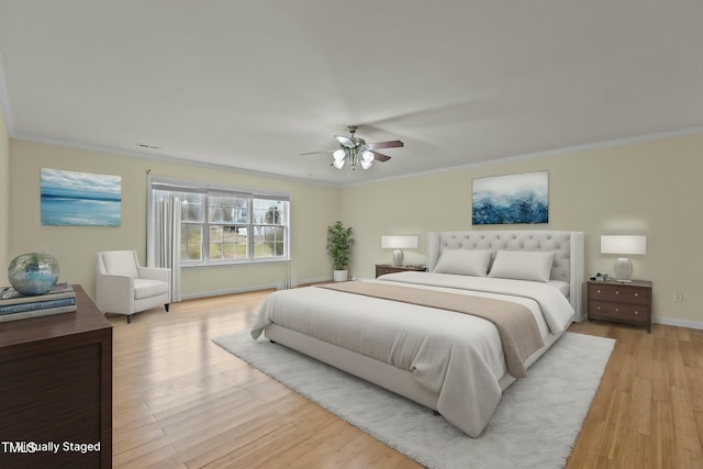 bedroom featuring crown molding, light wood-type flooring, and ceiling fan