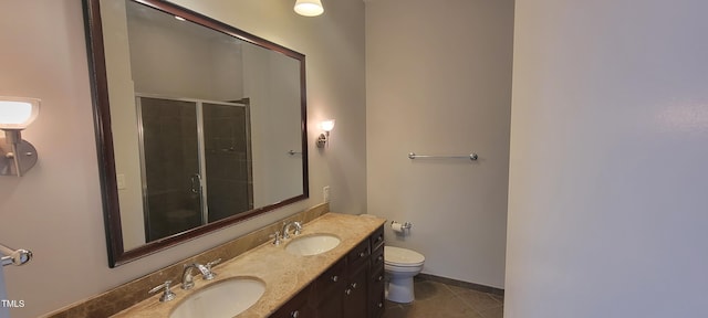 bathroom with toilet, vanity, tile patterned flooring, and a shower with door