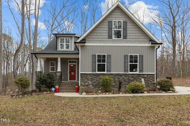 craftsman inspired home featuring a porch and a front yard