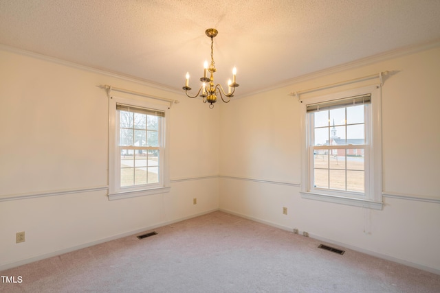 unfurnished room with carpet floors, ornamental molding, and a textured ceiling