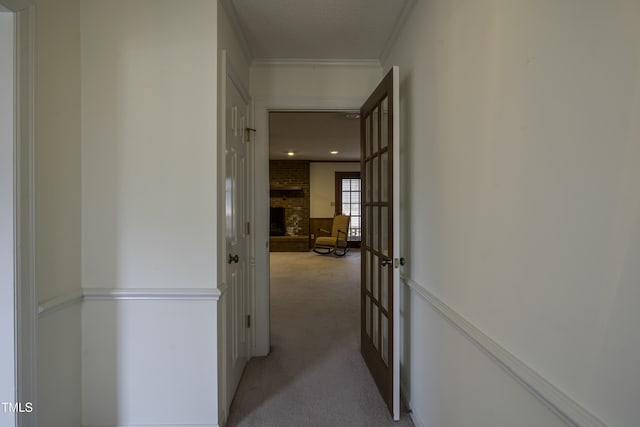 hall with crown molding, light carpet, a textured ceiling, and french doors