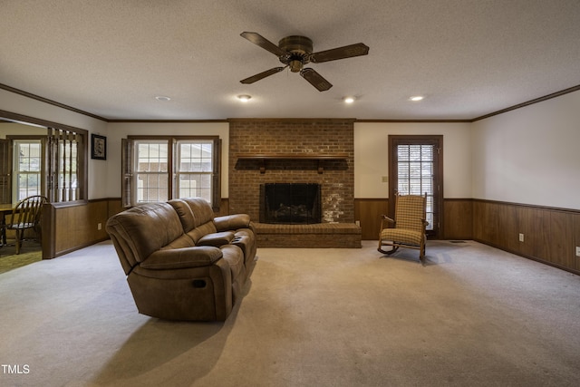 carpeted living room featuring plenty of natural light, a textured ceiling, and wood walls