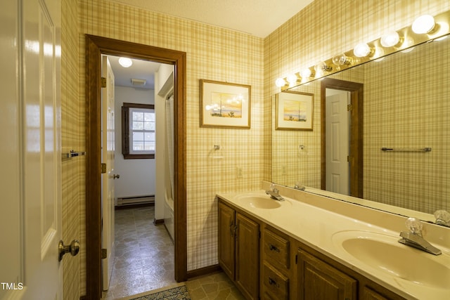 bathroom with vanity and a baseboard heating unit